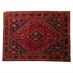 South West Persian Qashqai hand-knotted rug, madder red field with a large stepped diamond...