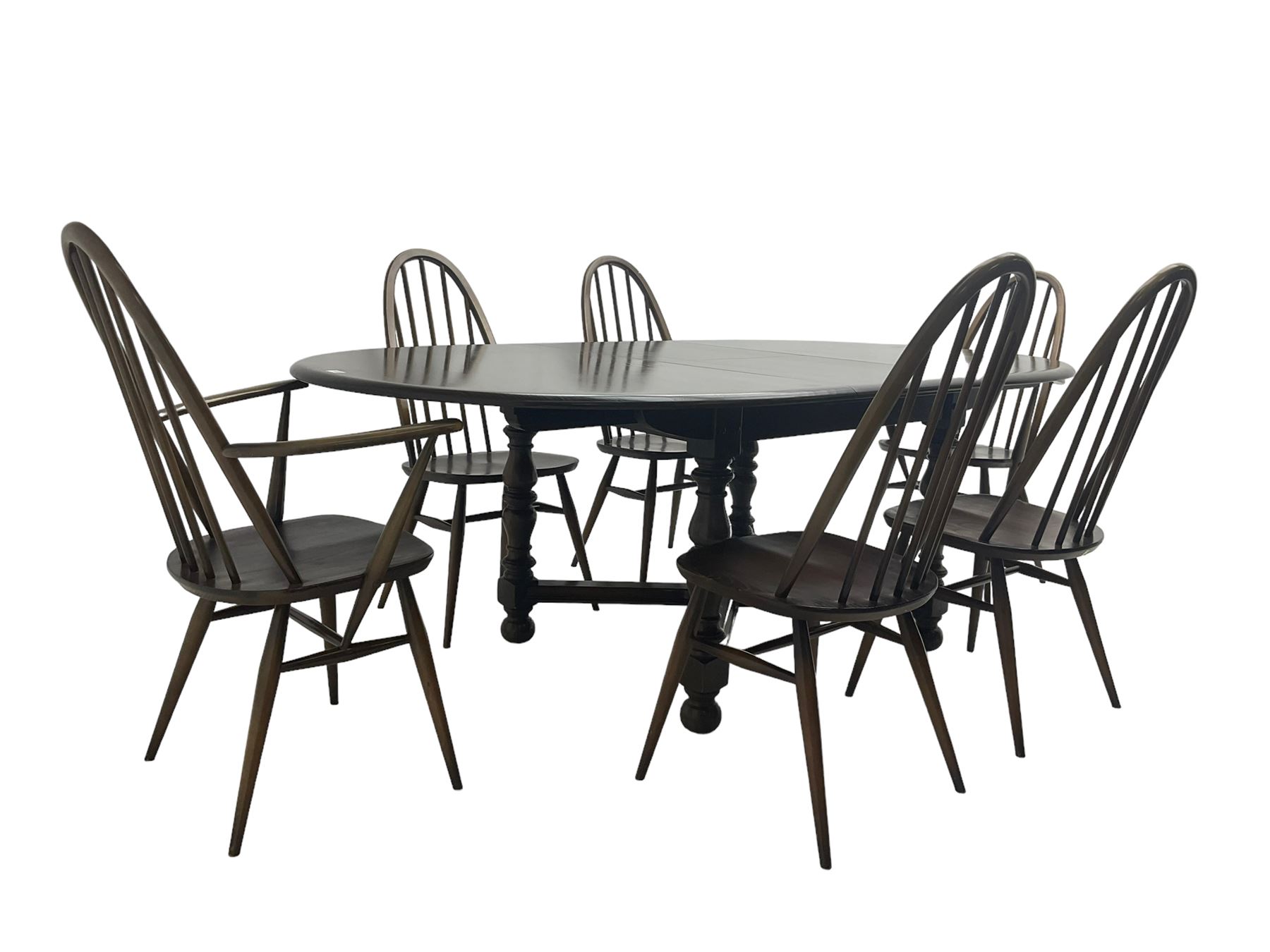 Ercol - 'Old Colonial' 705 elm extending dining table, oval top with hidden leaf, raised on turned supports united by X-stretcher (W163cm D108cm H72cm); and Ercol - set six  (4+2) dark elm 'Quaker Back Windsor Dining Chairs', hoop and stick backs 