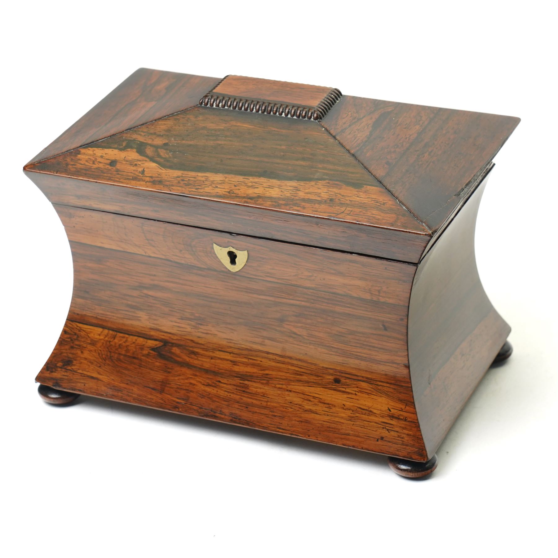 Early 19th century rosewood tea caddy of waisted sarcophagus form, twin compartments, on compressed bun feet, brass keyplate, H17cm W22cm 