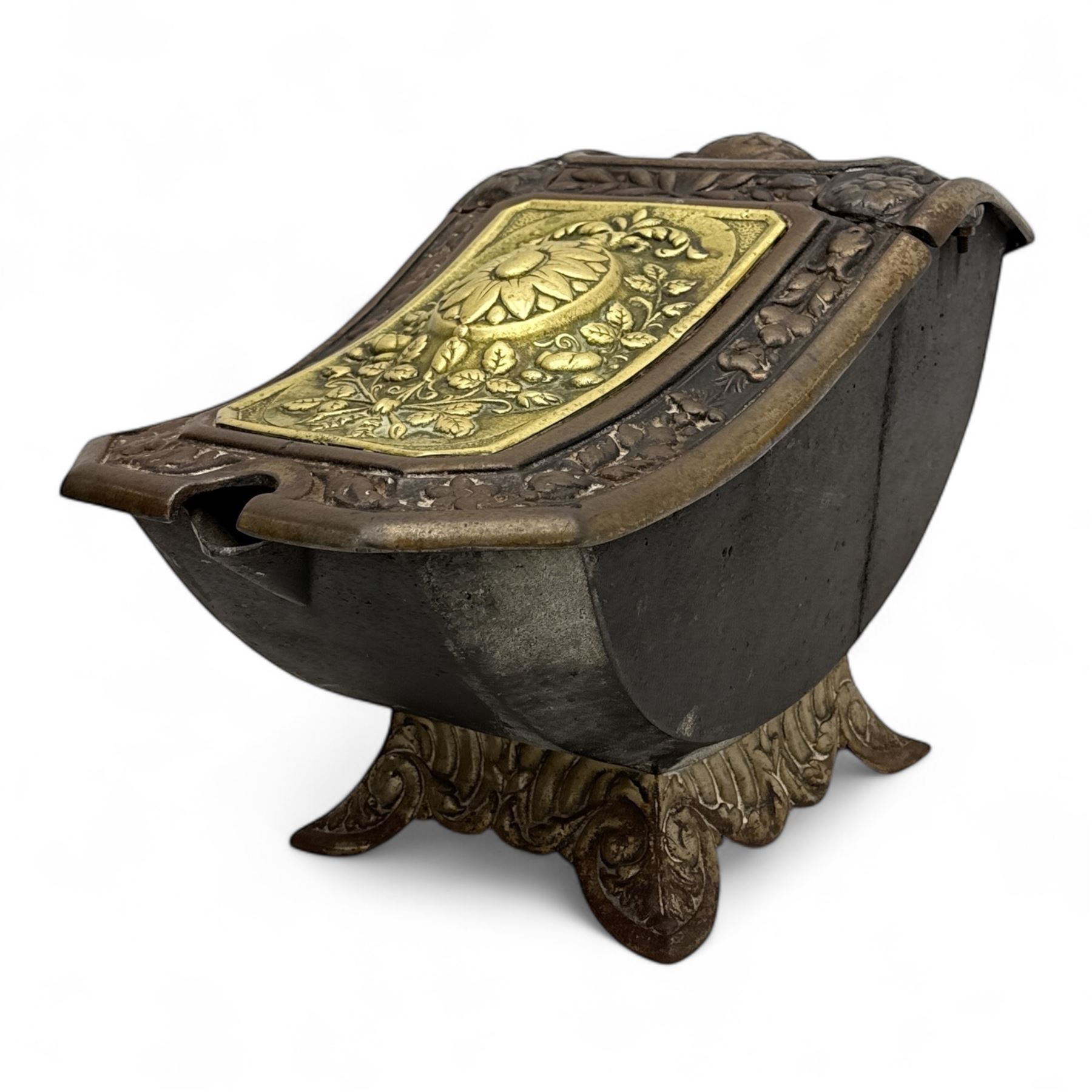 Late 19th century Victorian cast iron and brass purdonium, domed lid with central embossed sunflower and foliage panel within a floral border, flanked by scrolled and foliate detail, raised on shaped feet