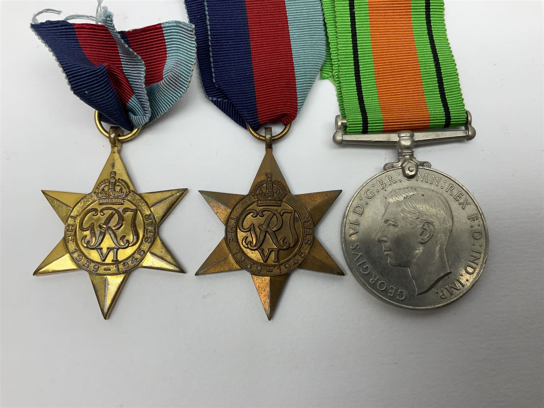 Twelve WW2 medals comprising four 1939-1945 war medals, four Defence medals, three 1939-1945 Stars and Africa Star; all with ribbons; some as groups in two issue boxes with slips
