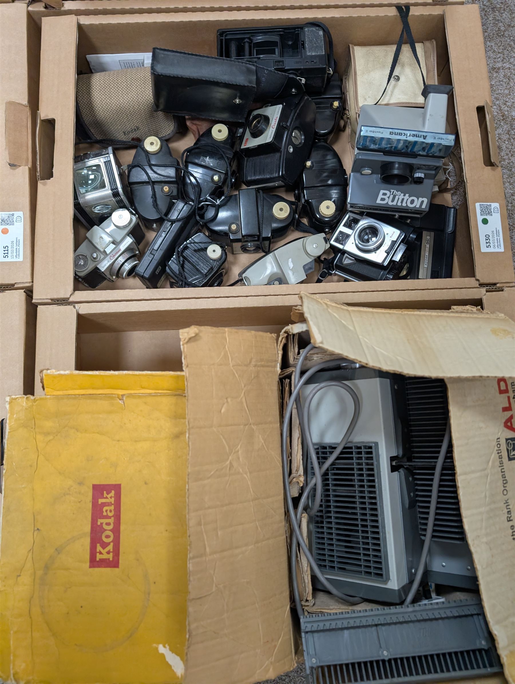 Collection of vintage cameras, projectors and accessories, including Kodak Brownies, Praktica, Polaroid, Ensign, light meters, flashes, etc