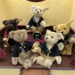 Steiff limited edition 'Millenium Dream Band' of five teddy bears on a stage playing various musical instruments, steps to the front and fitted velvet type curtains, wind-up musical movement playing 'When The Saints Go marching In' H60cm W50cm D31cm. Unboxed and lacking certificate.