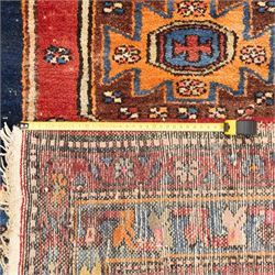 Persian Qashqai rug, wool on cotton foundation, triple stepped lozenge medallions with stylised motifs on a blue ground, within floral and geometric borders in rich red and cream
