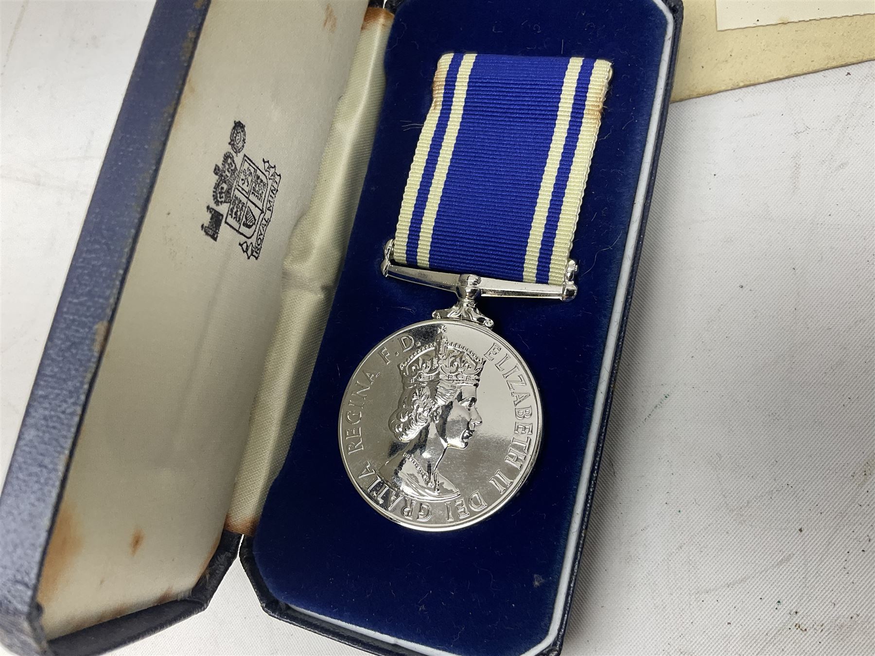 Archive of memorabilia and ephemera relating to Pc. (later Sgt.) Geoffrey Robinson of Dewsbury (later West Yorkshire) police force including cased Long Service and Good Conduct Medal; helmet plates and cap badges, collar numbers and uniform buttons, whistles, certificates, photographs, plaque etc 1960s - 1990s