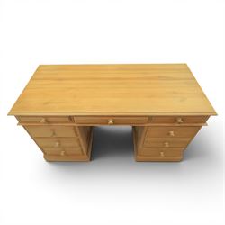 Solid pine twin pedestal desk, fitted with nine drawers, fielded panelled sides
