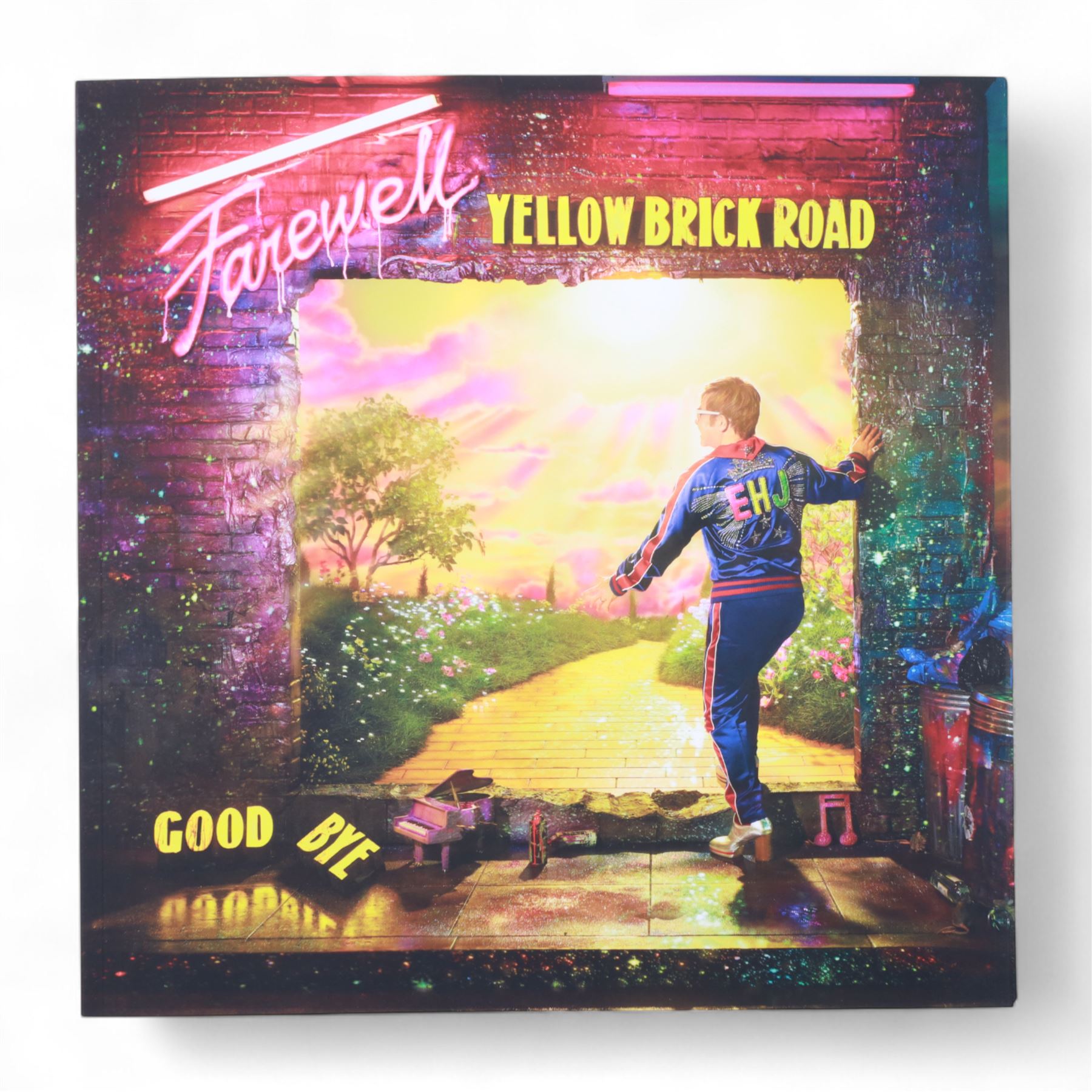 Elton John Farewell Yellow Brick Road tour merchandise, comprising programme, tote bag and VIP giftset with lanyard, wallet, luggage tag and keyring, in white box with gilt lettering, together with two limited edition Farewell Yellow Brick Road lithographs