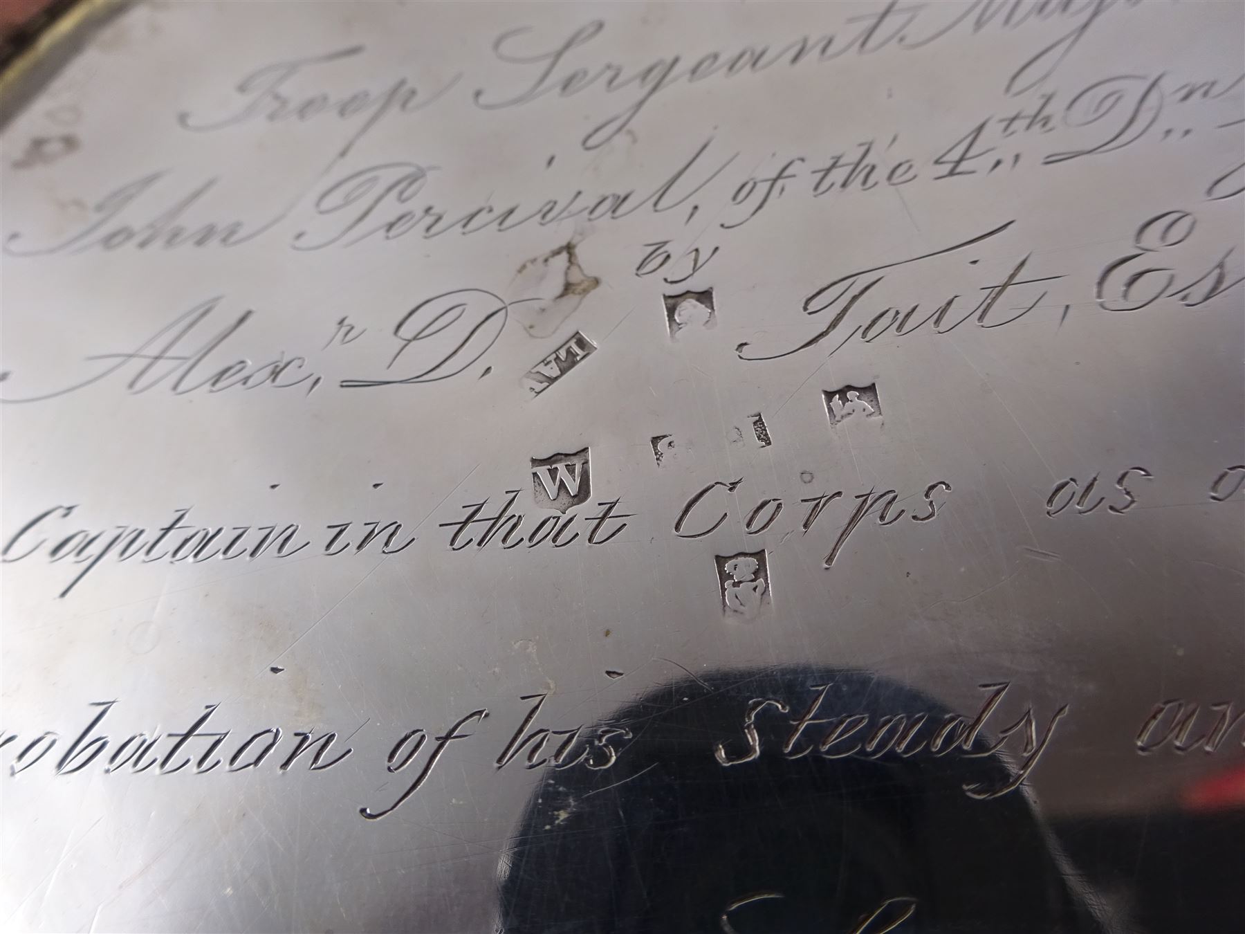 George III Irish silver teapot, of squat circular form, the body with repousse and chased floral and C scroll decoration, with capped C handle and ivory insulators, engraved to base 'Presented to Troop Sergeant Major John Percival, of the 4th Dragoon Guards by Alex D. Tait, Esq, late Captain in that corps as a mark of approbation of his steady and upright conduct when Sergeant Major of his Troop, Dublin, June 2nd 1843', hallmarked William Law, Dublin 1817, H12.5cm, This item has been registered for sale under Section 10 of the APHA Ivory Act