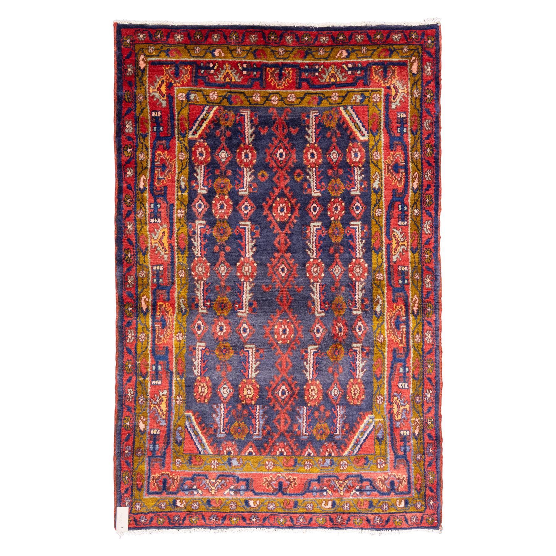 North West Persian Cirjan hand-knotted rug, indigo field decorated with vertical columns of stylized boteh, rosettes and diamond devices arranged in a repeating lattice and a chain of linked lozenges, enclosed by a mustard gold inner border and a principal border of madder ground, flanked by narrow guard stripes, with cotton fringe ends 