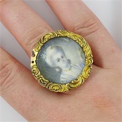 19th century gold portrait ring, set with a circular miniature of a young woman in 18th century dress on ivory, under a glazed panel, within a gold scroll frame and pierced gallery. This lot has been registered for sale under Section 10 of the APHA Ivory Act
