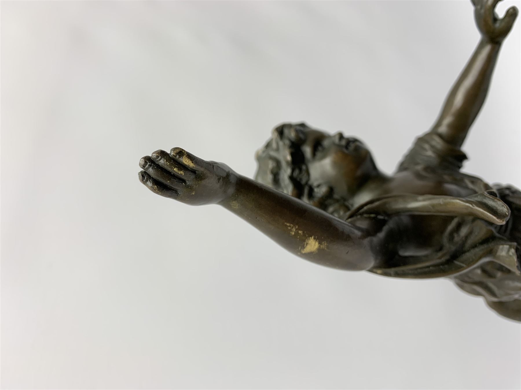 After E Plat, bronze modelled as a dancing child, signed E. Plat, upon cylindrical black marble base, H40cm