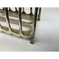 Silverplate Gothic style toast rack, with seven arched bars, openwork handle and bracket feet, H17.5cm