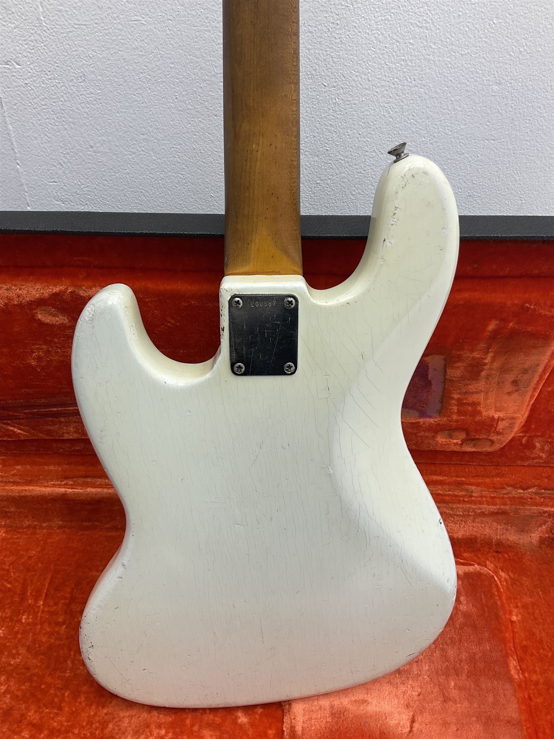 1963 Fender Jazz three-knob bass guitar; impressed with date code 7AUG63A on end of neck and serial no.L08587 on back plate; all original but re-finished in white in the 1970s; sold with photographs of the instrument in the 1960s with original finish and in the 1970s re-finished; L117.5cm; in original hard carrying case; Provenance: the professional guitar of Howard Livett from new to his death in 2005. Howard played in The Humperdincks, the backing group for Englebert Humperdinck, also played in the backing group for Max Bygraves and in the band Hedgehoppers Anonymous. The guitar is also sold with a manuscript letter of provenance from Howard's wife.
