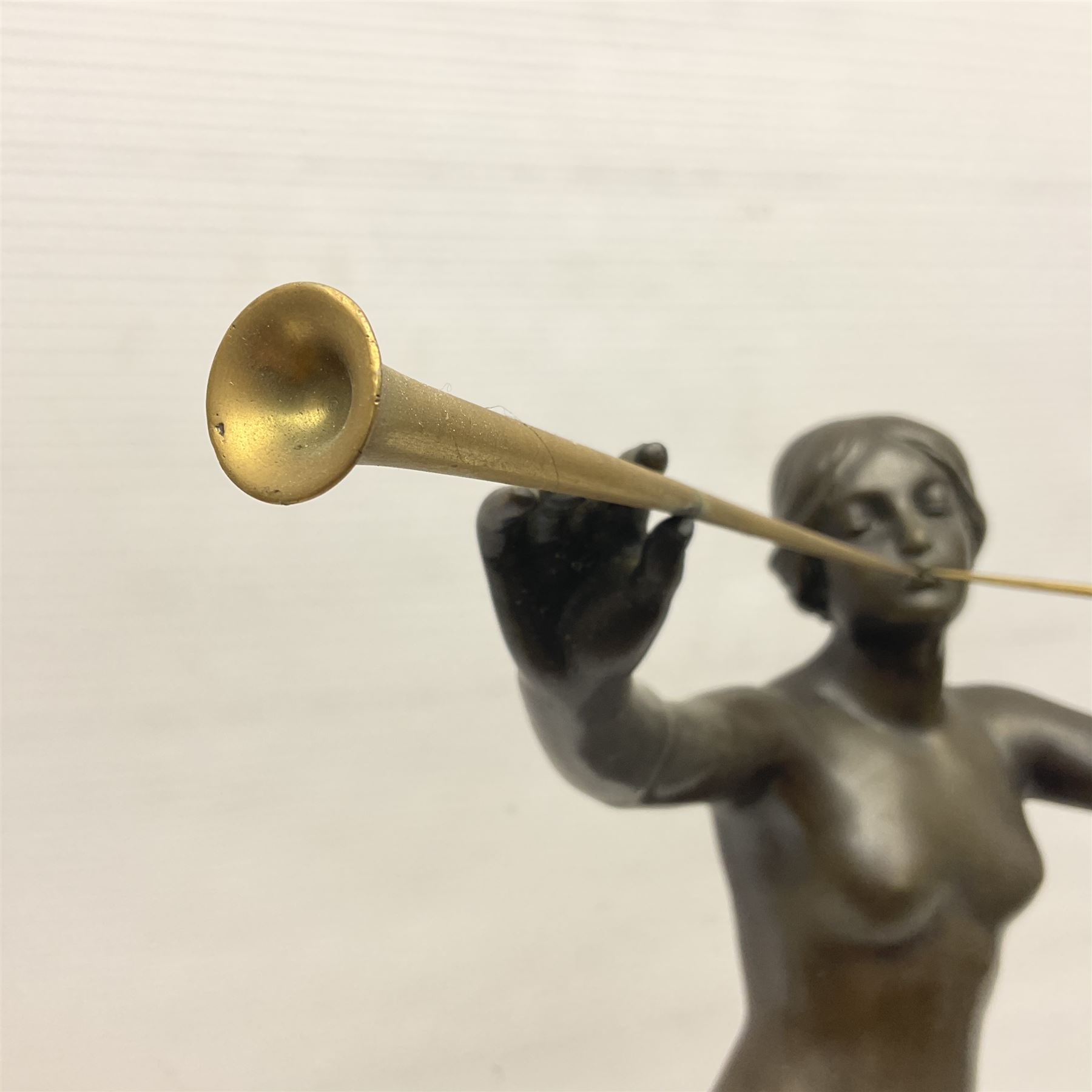 After Eugen Schlipf, Fanfair, bronzed female figure playing two horns, upon a circular marble plinth, H57cm