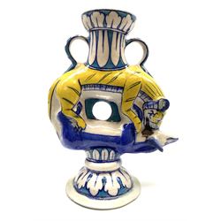 An early 20th century pottery twin handled vase, probably Persian, modelled as a tiger attacking an antelope and further detailed with leaf borders, H22.5cm. 