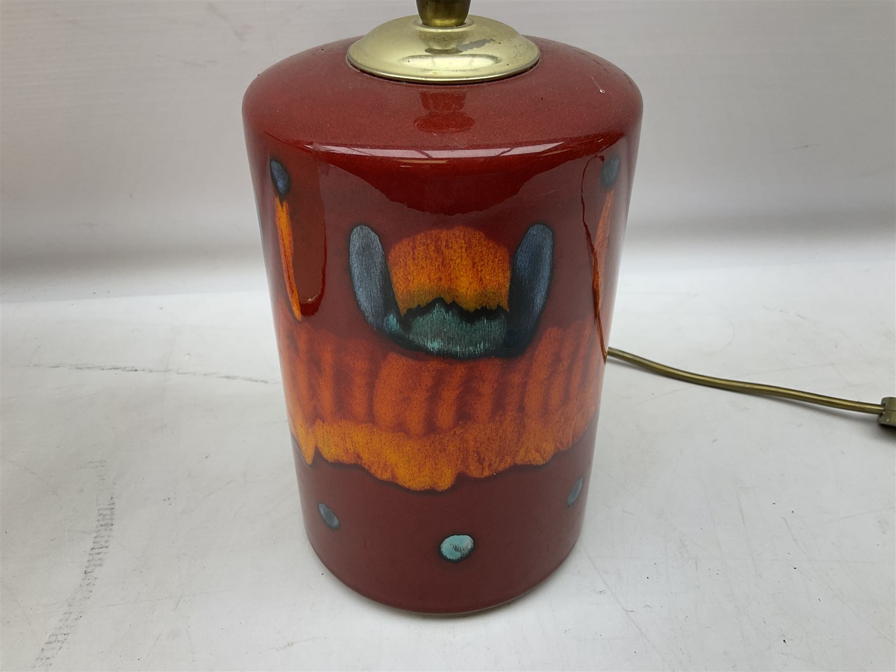 Poole Pottery table lamp in Volcano pattern of cylindrical form, with a cream lampshade, lamp H30cm