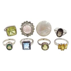 Seven silver stone set rings including citrine, quartz, mystic topaz, blue topaz and mother of pearl, all stamped 925 and a rose quartz pewter ring