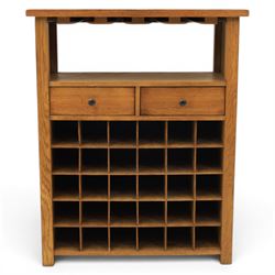 Traditional design light oak wine server, rectangular overhanging top above an open undertier with grooves for wine glasses, fitted with two drawers, lower section with open bottle racks for thirty five bottles, raised on square supports
