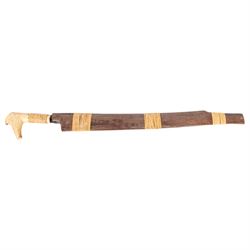 Borneo Dayak Mandau knife, with carved bone handle and wooden scabbard, overall L64cm