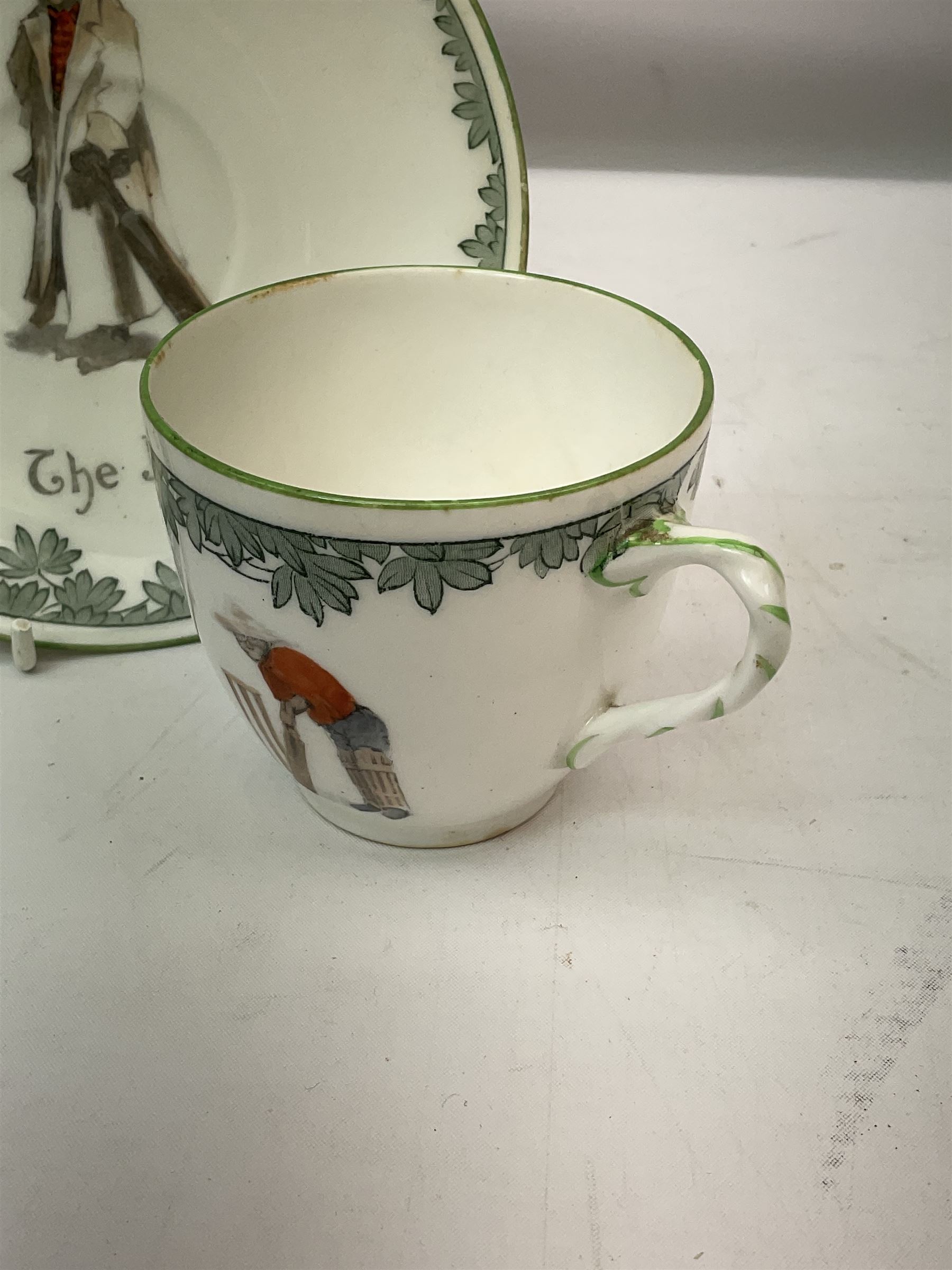 Early 20th century Royal Doulton teacup and saucer, from the series 'The All Black Team', the teacup depicting a cricketer entitled 'Good for fifty', the saucer depicting a cricketer stood in a long coat and wide brimmed hat, entitled 'The Boss', both with printed mark beneath, cup H6.5cm