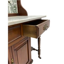 Edwardian walnut washstand, raised tiled back over marble top, the base fitted with two drawers and cupboard, turned supports with castors 