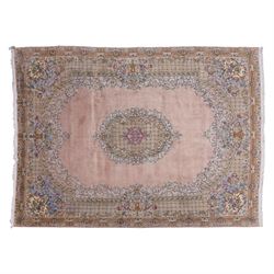 South East Persian Kirman hand-knotted rug, pale blush field with central scalloped medall...