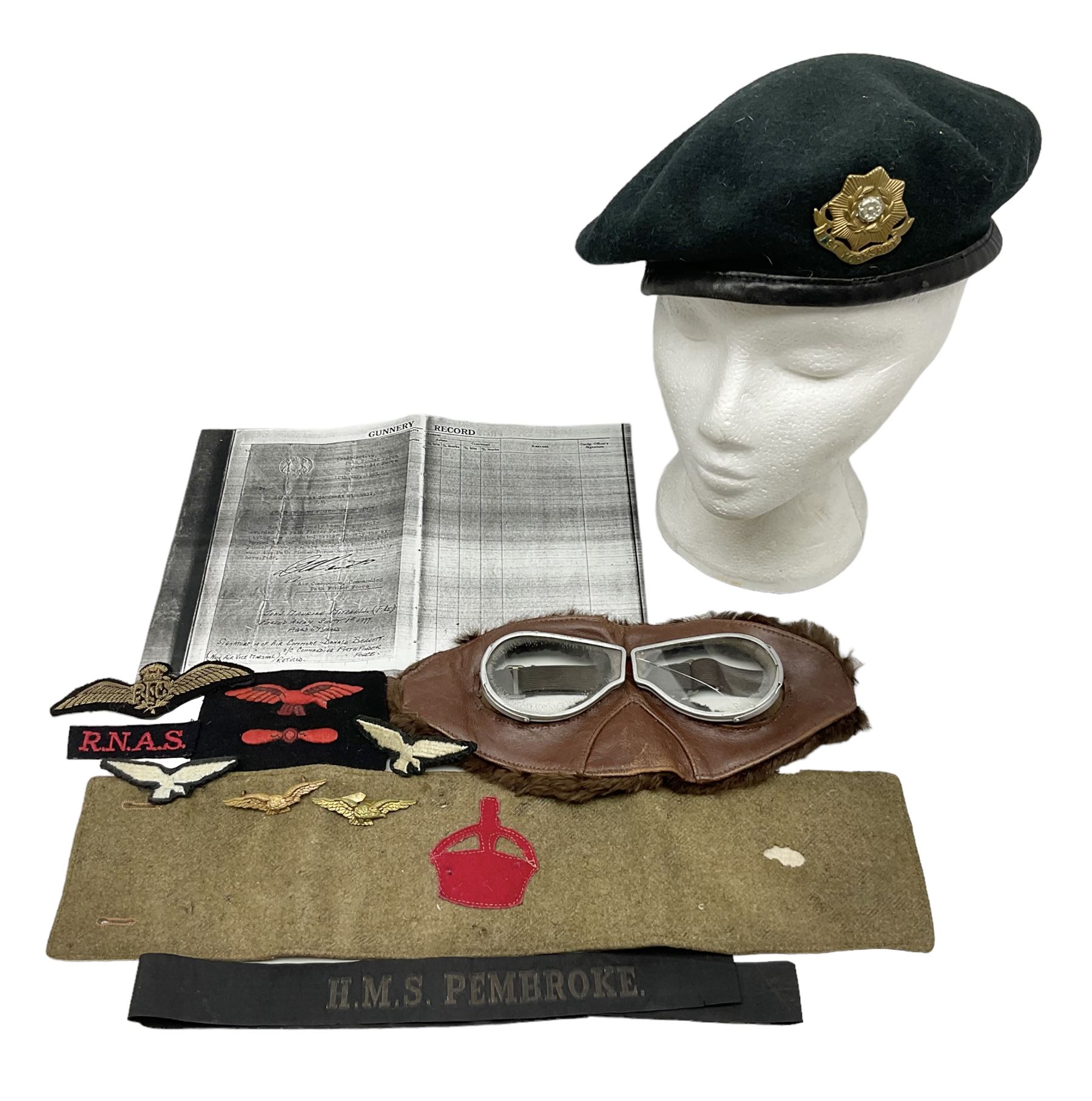 WW1 British Army Derby Scheme 1915 Attested armband; beret with East Yorkshire cap badge; pair of fur lined leather flying/motorcycle goggles; HMS Pembroke cap band; and small quantity of RNAS cloth and metal badges etc