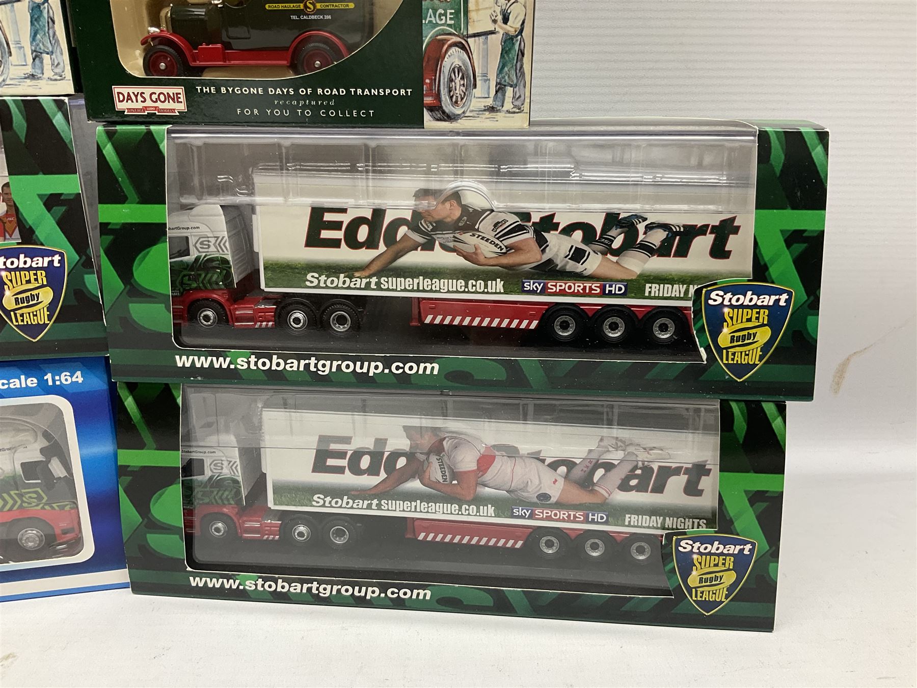 Eddie Stobart - three Oxford Die-Cast Super Rugby League lorries in perspex display cases including the two Hull Clubs; two Lledo Vanguard vans; two Days Gone vans; and Saico Truck & Trailer; all boxed; together with fourteen unboxed Corgi and other tractor/cab units etc (23)