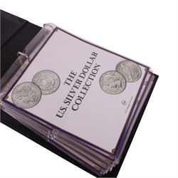 Twenty-five United States of America silver one dollar coins, comprising eighteen 'Morgan' and seven 'Peace' dollars, in 'The U.S. Silver Dollar Collection' ring binder