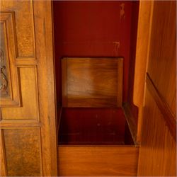 Late Victorian oak and burr oak three-section mirror wardrobe, central door with three carved panels with shell and acanthus decoration, fitted with four drawers and four tray drawers, linen sides with bevelled mirrored panel doors with hanging space, plinth base, and dental cornice