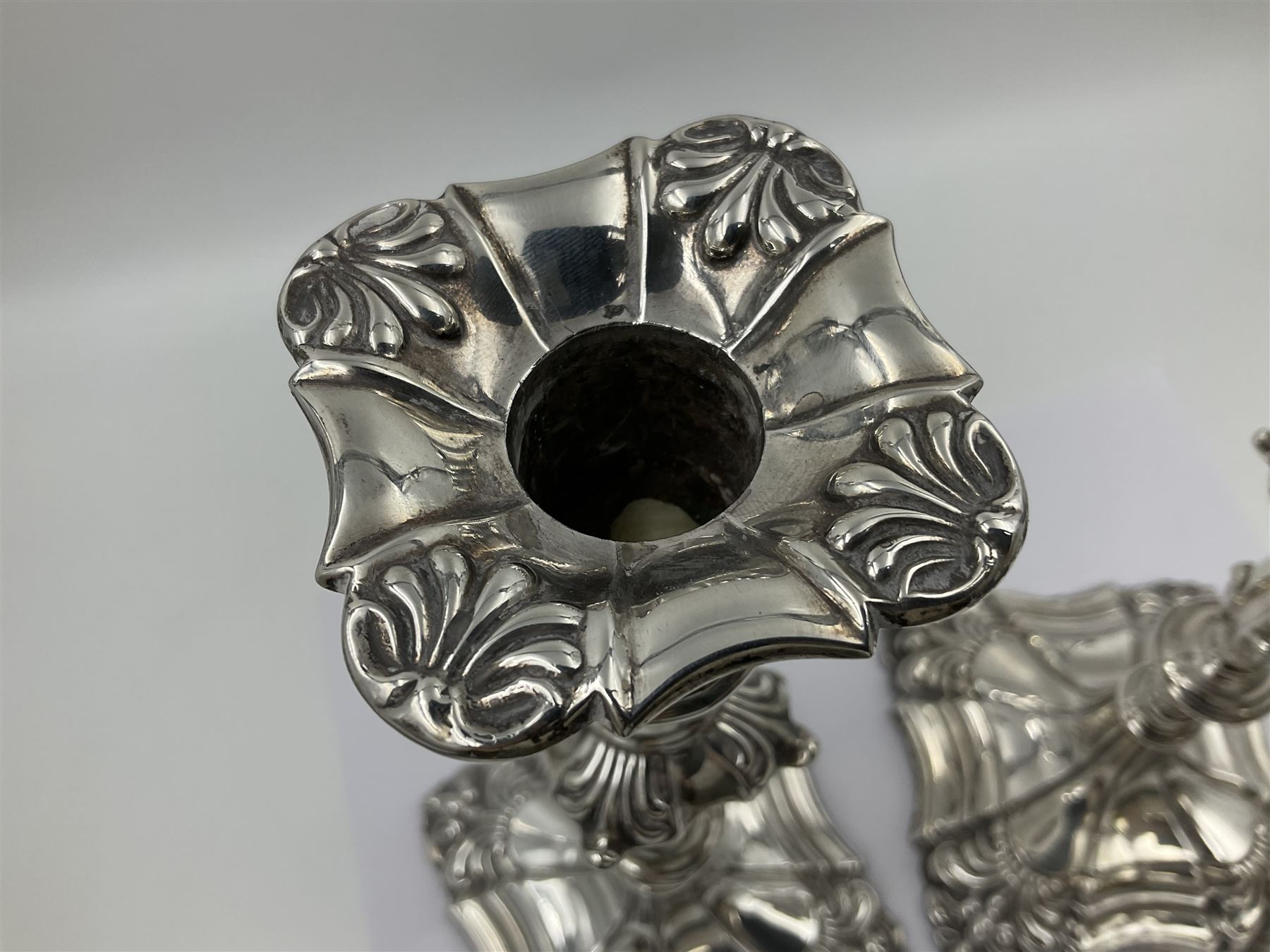 Pair of late Victorian silver mounted candlesticks, each of knopped and part fluted form, upon square stepped base with anthemions to each corner, with conforming sconces, hallmarked to removable sconces and foot, Thomas A Scott, Sheffield 1901, H25.2cm