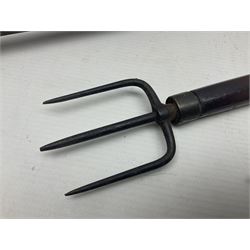 Two late 19th century fruit picker canes, the first example a French ebonised bamboo cane, with pair of fruit scissors to base, the handle stamped Cueille Fruit, the second example with grabbing action, the cap stamped A C Harris, Leicester, together with two other 19th century canes, one with fork and the other with hoe