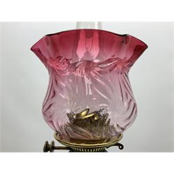 20th century Hawksworth, Eyre & Co silver plated oil lamp, the octagonal stepped base with engraved dedication, leading to an octagonal column supporting a faceted clear glass reservoir, Hinks Duplex burner, clear glass chimney, and cranberry glass shade, overall H71.5cm