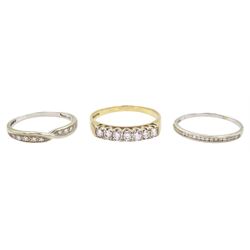 Two white gold diamond half eternity rings and a yellow gold seven stone cubic zirconia ring, all hallmarked 9ct