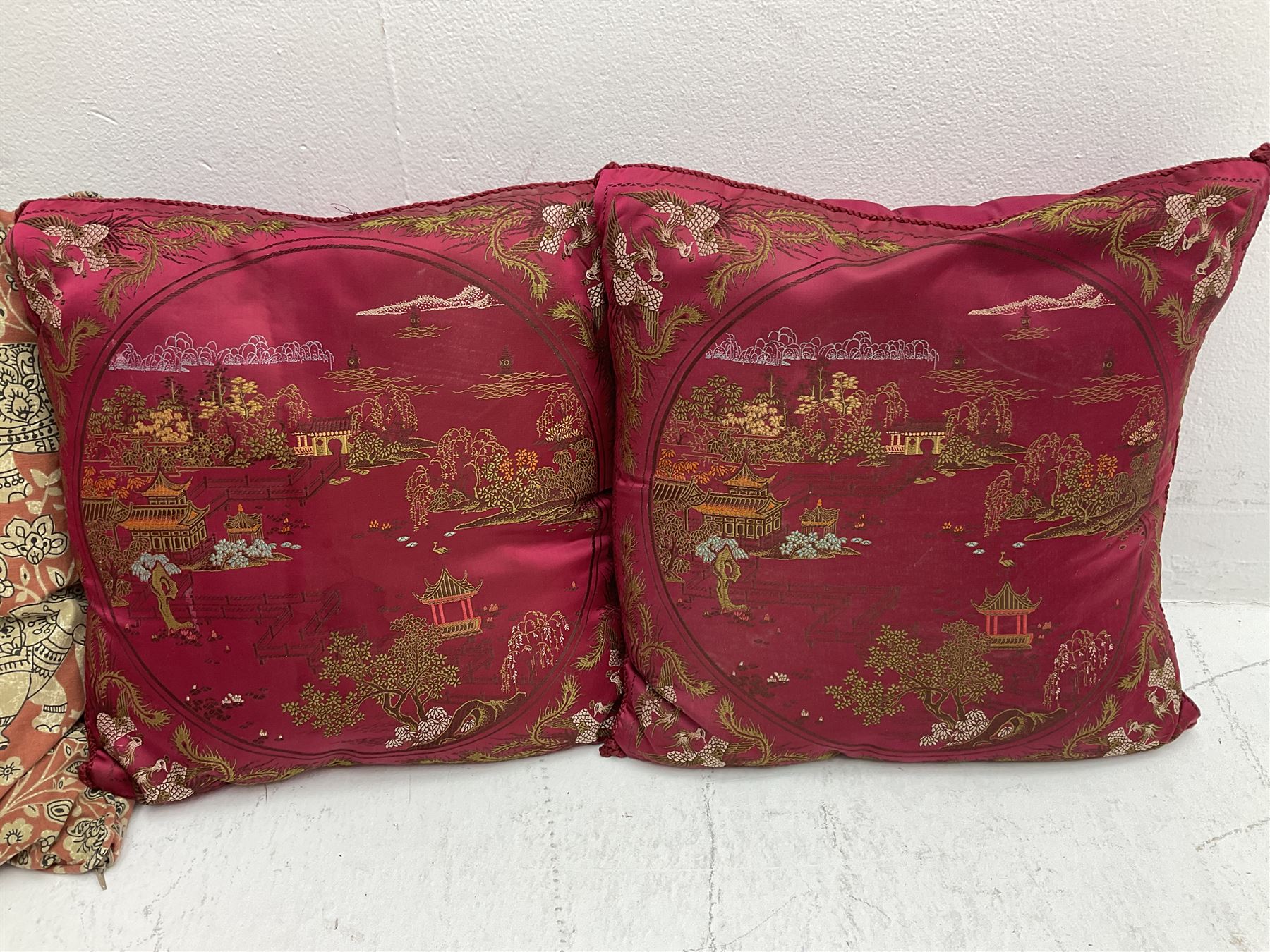 Collection of predominantly Chinese style cushions, to include feather down examples