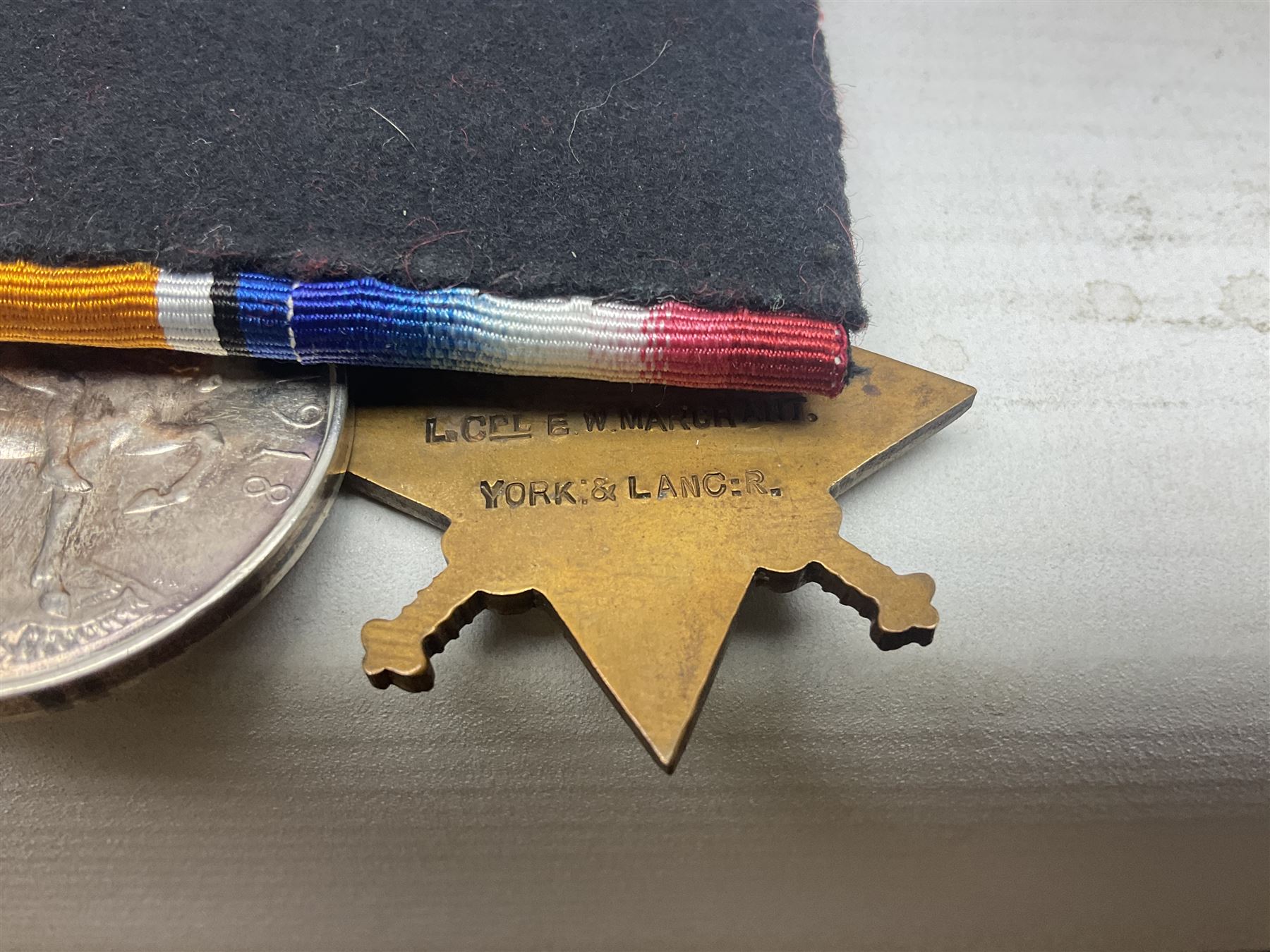 WW1 group of three medals comprising British War Medal, 1914-15 Star and Victory Medal together with bronze Memorial Plaque named to 18397 Pte. E. W. Marchant Y. & L. R.; with ribbons; displayed on modern board for wearing