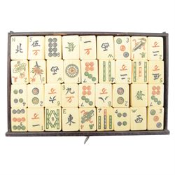 20th century Chinese Mahjong set, with five drawers containing bone counters and tiles, contained within a wooden box with brass detailing, together with a set of eight wooden Mahjong tile trays