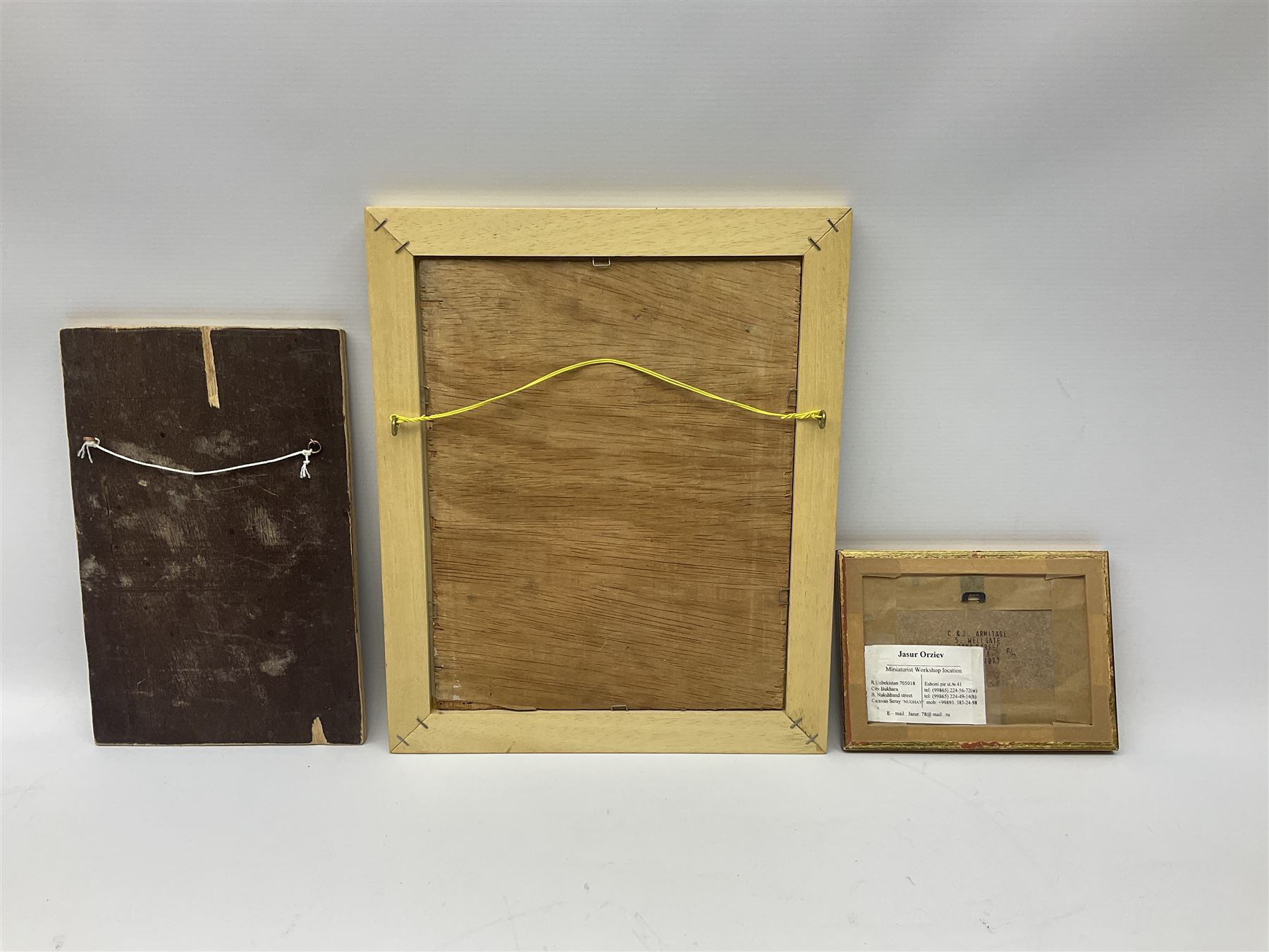 Jasur Orziev (20th century): Couple playing Sitar, miniature gouache signed; African School (20th century): Woman with Bowl on Head, sand on board signed CA together with another sand painting with hands on a globe inscribed Abaraka max 29cm x 23cm (3)