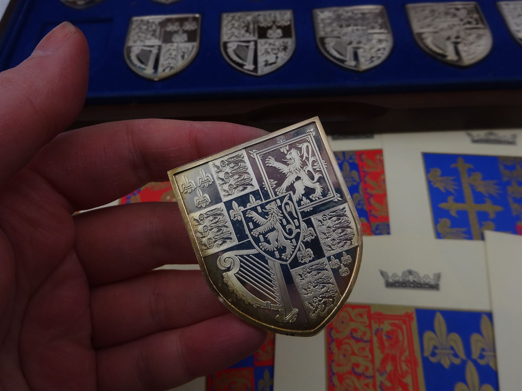 Yorkshire Mint, The Royal Arms Collection, twelve shield shaped silver medallions each depicting variations on the Royal coat of arms, each hallmarked Yorkshire Mint, Birmingham 1976/77, contained within fitted wooden case with associated information cards