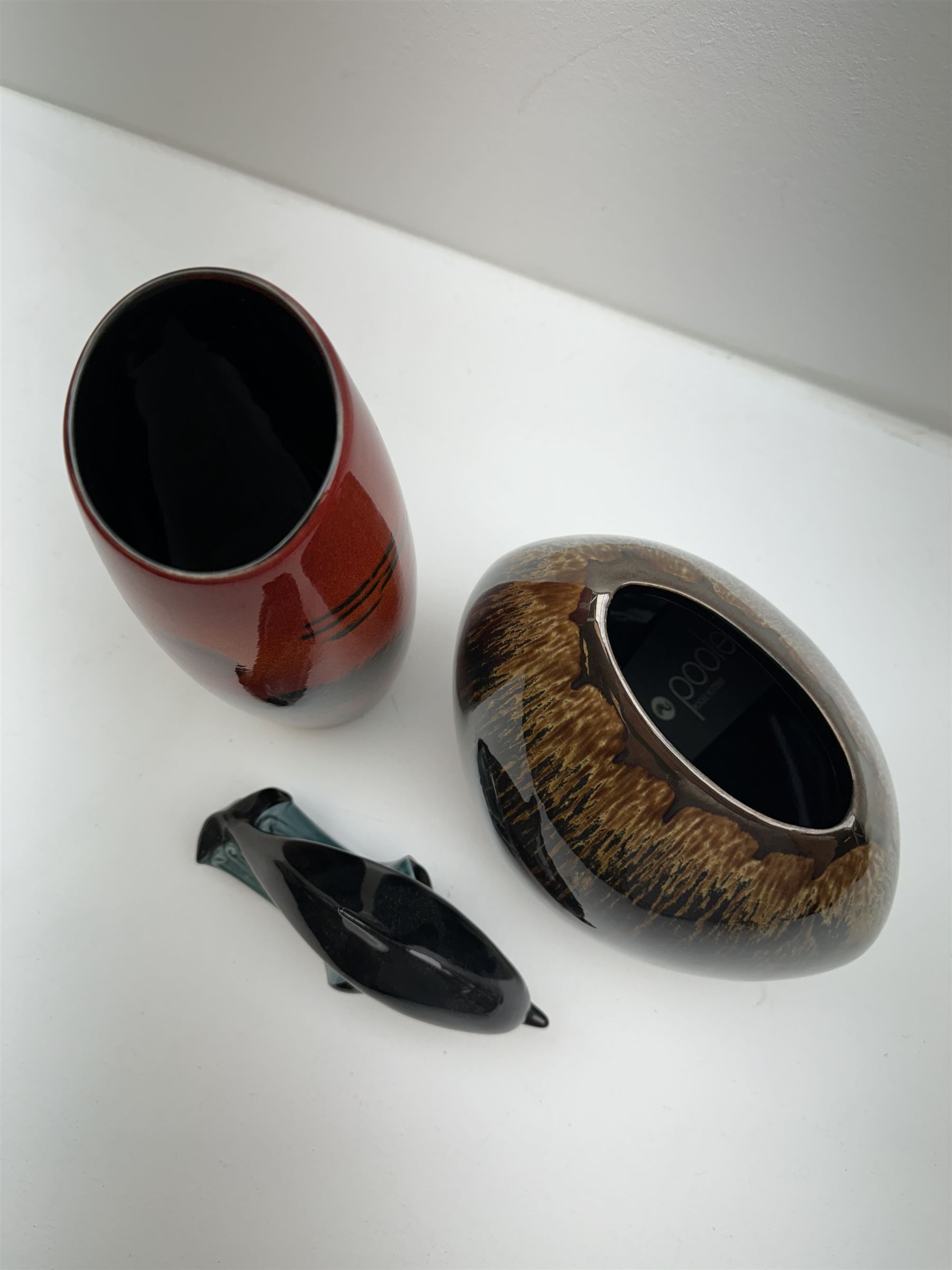 Poole pottery Form vase by Andrew Tanner, decorated with a silhouette of a tree beneath a red sun, together another with Poole pottery vase and dolphin, largest H24cm 