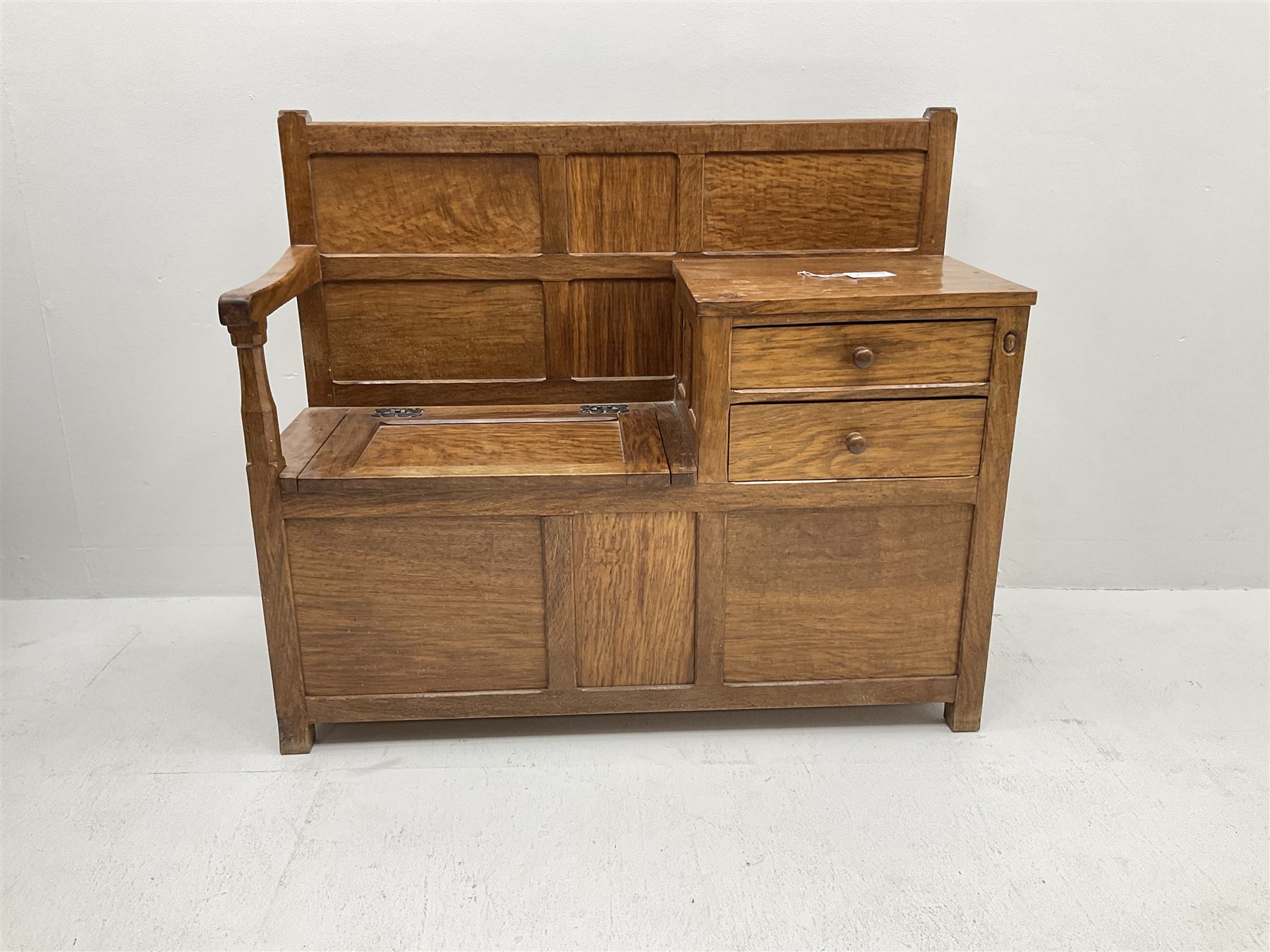 'Acornman' figured oak telephone table, panelled back above hinged seat and two drawers, panelled sides and front, all over adzing, by Alan Grainger of Brandsby, York