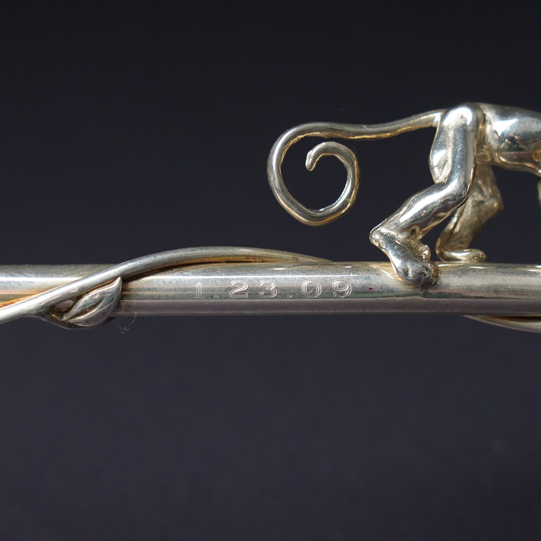 A pair of Tiffany & Co. novelty silver drinking straws, each modelled as a bamboo stem entwined with leaves and applied with a climbing monkey figure, engraved with names and date, stamped TIFFANY & CO. 925, W21cm
