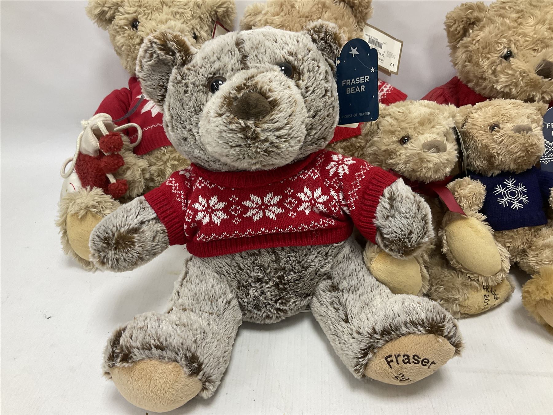 Eight annual Fraser Bears, by House of Fraser, dating between 2012 and 2019, tallest H35cm
