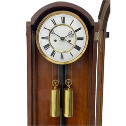 Lenzkirch – 8-day walnut cased weight driven Vienna regulator manufactured 1877-1878, with a break-arch pediment surmounted by a turned finial on a raised cavetto molding, fully glazed arched  door flanked by long ring turned pendants, flat base with open fretwork and two short pendants,  two piece enamel dial within a brass slip, Roman numerals, minute track and pierced steel hands, wooden pendulum with a brass faced bob, two brass cased weights and pulleys, dead beat escapement with a rack striking movement sounding the hours and half hours on a coiled gong, movement serial number 421410. 
Lenzkirch were one of Germanys most highly respected clock manufacturers of the 19th century, founded in the late 1850s the company produced movements and cases of high quality up until 1932.
