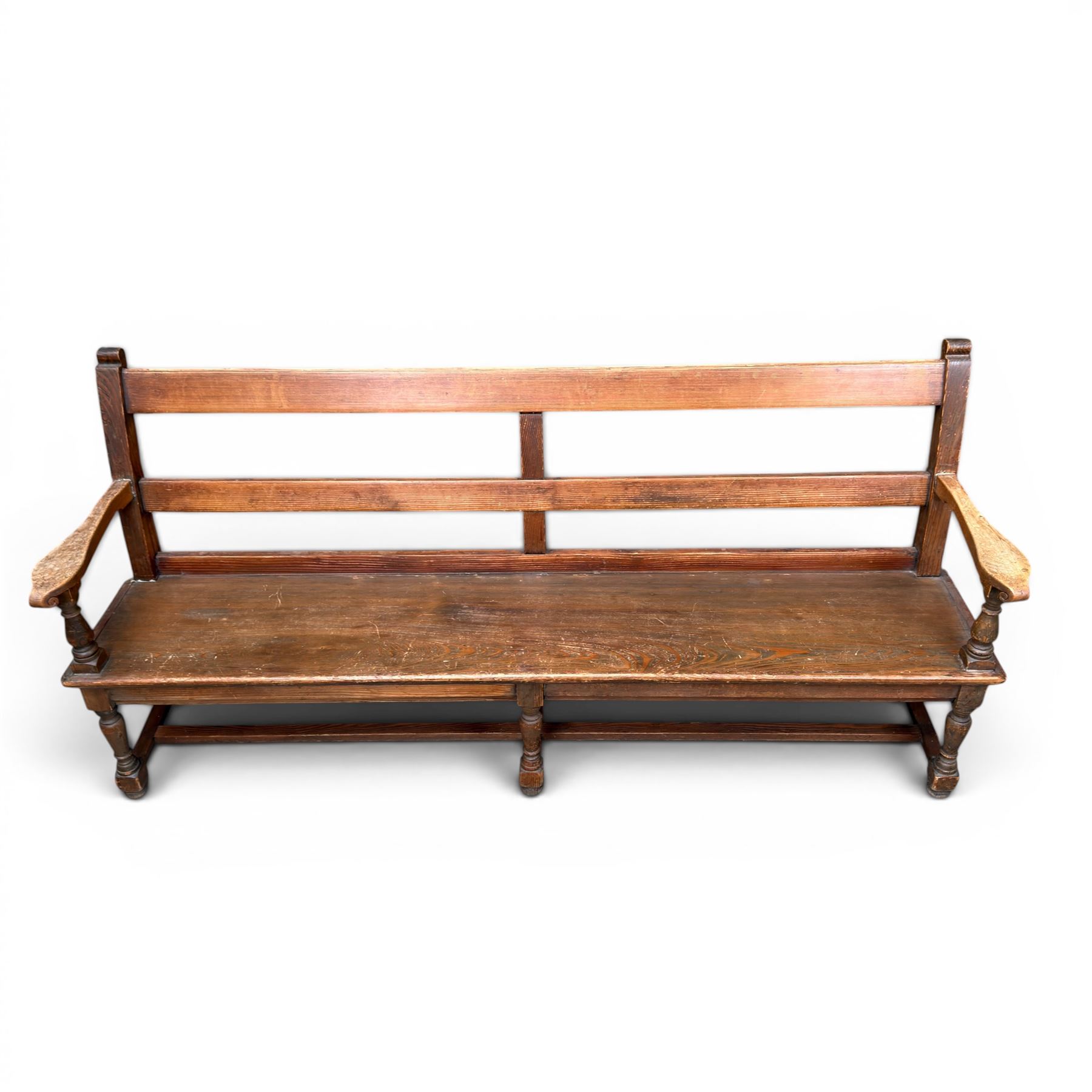 Early 20th century pine and oak bench seat, stained pine rail back frame with shaped oak arms