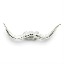 Contemporary cast metal bull skull wall ornament, polished silver finish with textured detailing and outstretched curved horns  