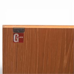 G-Plan - ‘Brasilia’ teak sideboard, rectangular top with moulded edge above a central bank of four drawers flanked by cupboard doors with carved sculptural handles, raised on tapering supports
