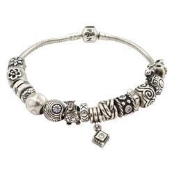 Pandora silver bracelet with fifteen Pandora charms, including turtle, mother of pearl heart, giraffe and flower, all stamped 