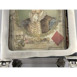 Edwardian silver mounted playing card case, hallmarked William Harrison Walter, Birmingham 1903, the sides each with a period playing card set behind a bevelled glass panel, the hinged cover with later engraving 'Presented to Norman T Crombie Esq by the officers & men of the 31st WR Detachment for services rendered 1917-1918', with red leather lined interior, the three compartments upon a sprung base and containing two later wooden Whist markers, case H12.5cm