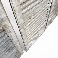 Five 19th century full height French Chateau louvre doors, pitch pine painted in cream finish, two having iron rod hinges, dimensions approx.